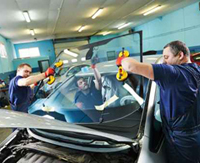 Workers doing the final touches in the vehicle production line.