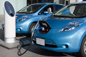 Electric vehicles charging at stations.